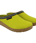 Grizzly GZ - Pistachio-colored wool felt house slipper, shown from the side, featuring white, green, and red webbing trim around the upper edge.